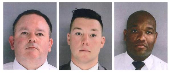 In this photo provided by the Delaware County District Attorney's Office on Tuesday, Jan. 18, 2022, Sharon Hill Police officers Brian Devaney, left, Sean Dolan and Devon Smith are shown. (Delaware County District Attorney's Office vis AP)