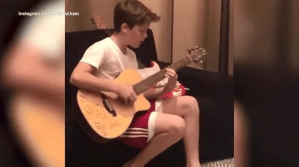 Cruz Beckham playing guitar 2018