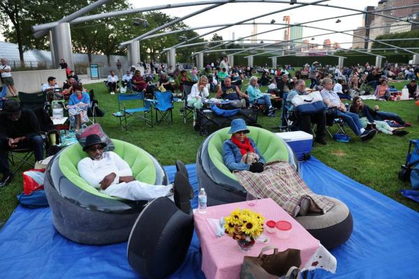 James Jackson and Janet Walker relax on the lawn while taking in the opening night of the Chicago Jazz Festival in Millennium Park’s Pritzker Pavilion on Aug. 31, 2023.  